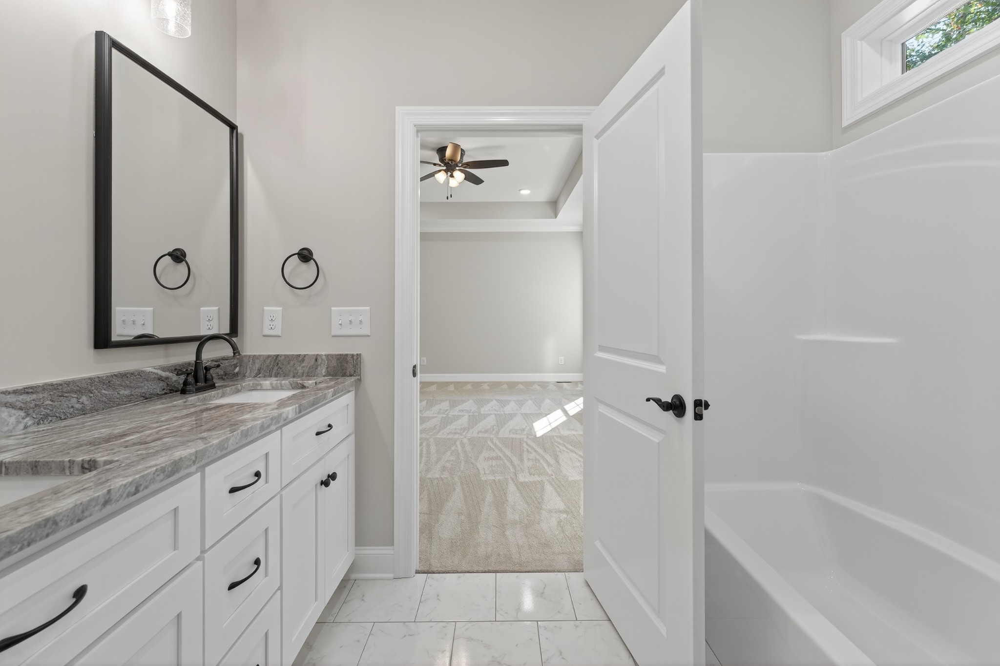702 Meadow Road Mount Pleasant, TN 38474 - Photo 32 of 51 a bathroom with a granite countertop sink a mirror and a bathtub