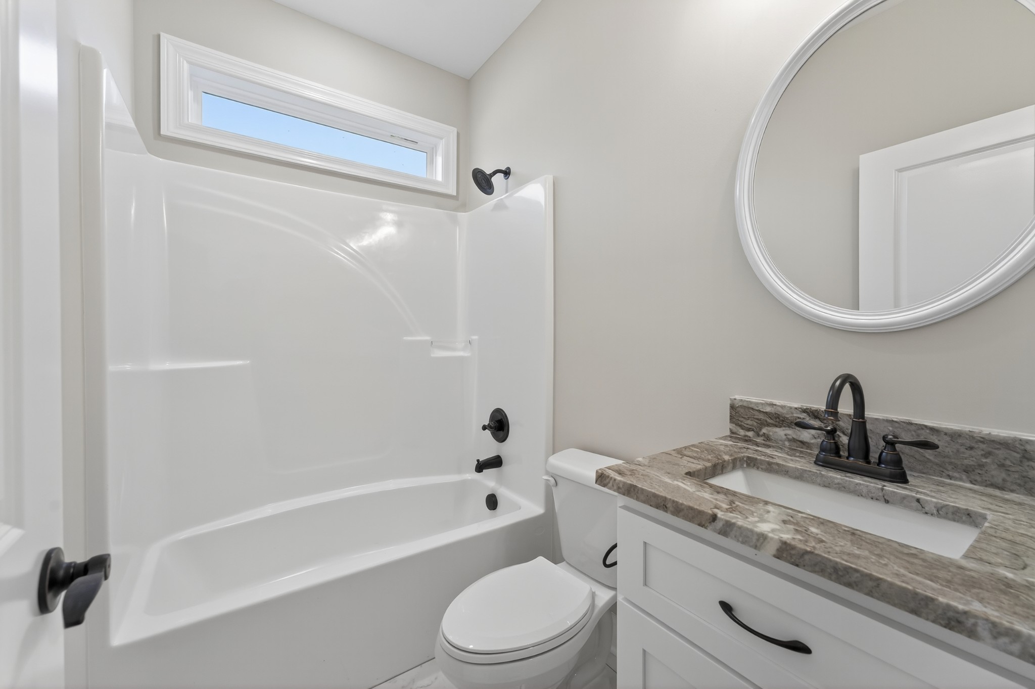 702 Meadow Road Mount Pleasant, TN 38474 - Photo 40 of 51 a bathroom with a granite countertop sink a toilet and a mirror