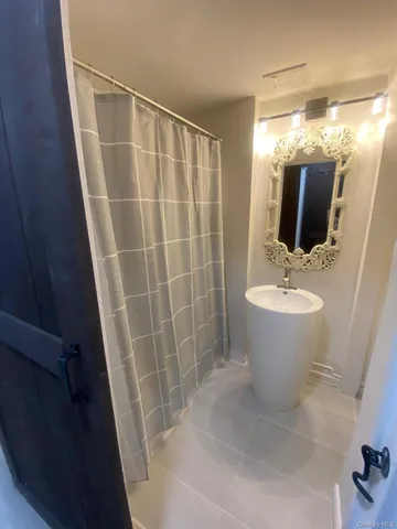 a bathroom with a sink a mirror and tub