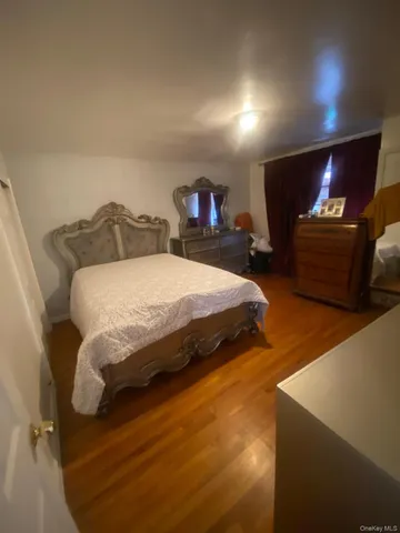 a spacious bedroom with a bed and a flat screen tv