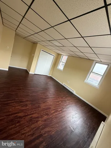 a view of a room with wooden floor
