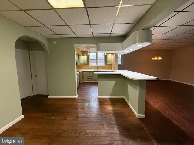 a view of entryway with kitchen island dining table and chairs