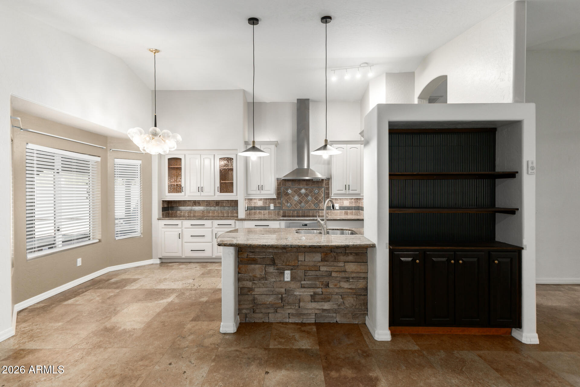 16426 South 29th Street Phoenix, AZ 85048 - Photo 3 of 21 a kitchen with kitchen island a counter top space a sink stainless steel appliances and cabinets