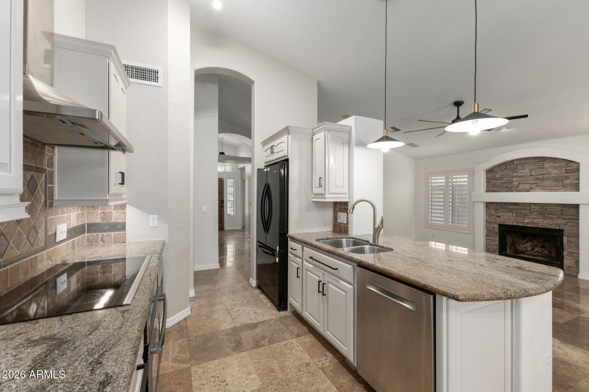 16426 South 29th Street Phoenix, AZ 85048 - Photo 5 of 21 a kitchen with stainless steel appliances granite countertop a sink a stove and a refrigerator