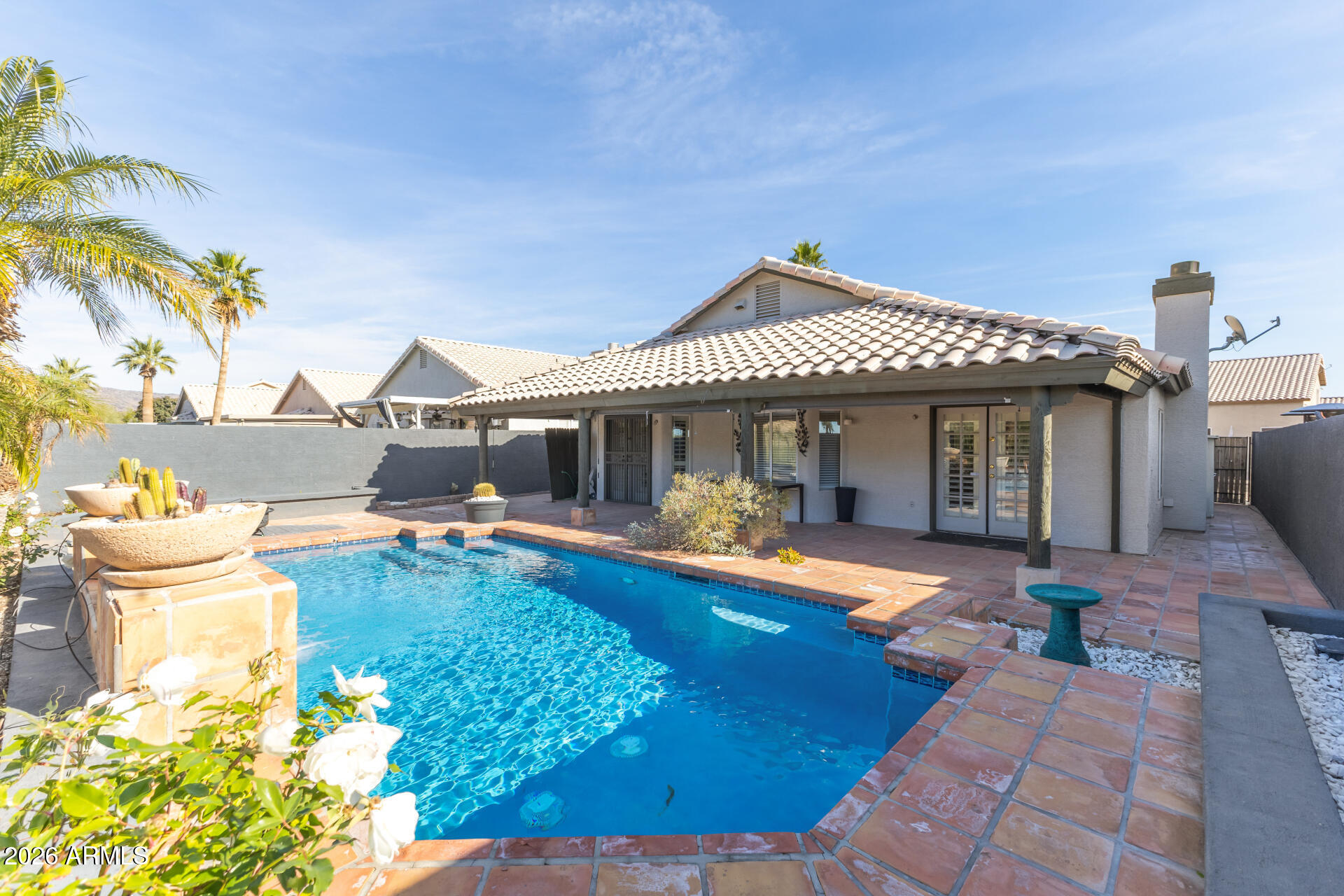 16426 South 29th Street Phoenix, AZ 85048 - Photo 9 of 21 a front view of a house with swimming pool garden and patio