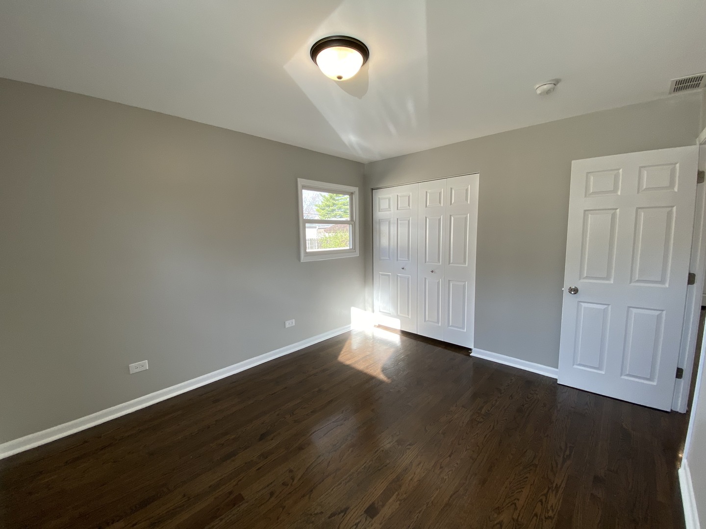 18 South Oltendorf Road Streamwood, IL 60107 - Photo 13 of 21 an empty room with wooden floor and windows