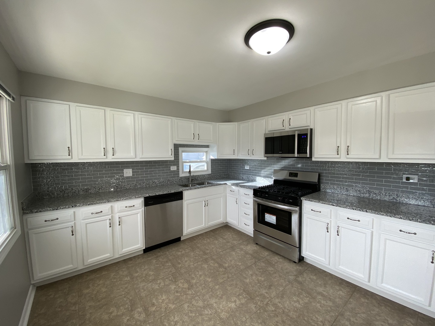 18 South Oltendorf Road Streamwood, IL 60107 - Photo 3 of 21 a kitchen with granite countertop white cabinets and white appliances