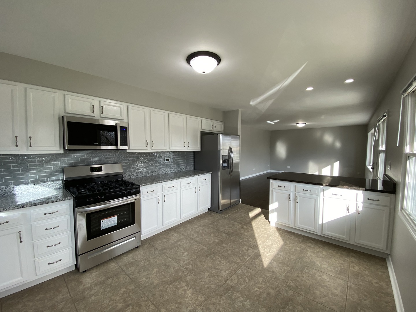 18 South Oltendorf Road Streamwood, IL 60107 - Photo 4 of 21 a kitchen with granite countertop white cabinets and stainless steel appliances