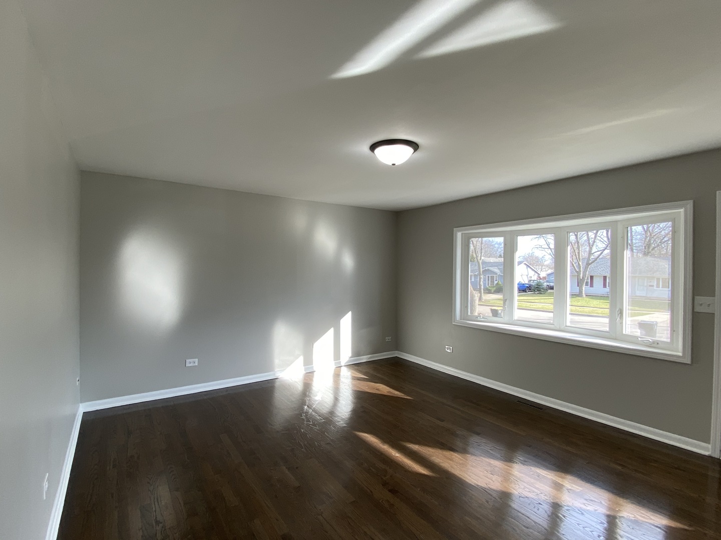 18 South Oltendorf Road Streamwood, IL 60107 - Photo 7 of 21 an empty room with wooden floor and windows