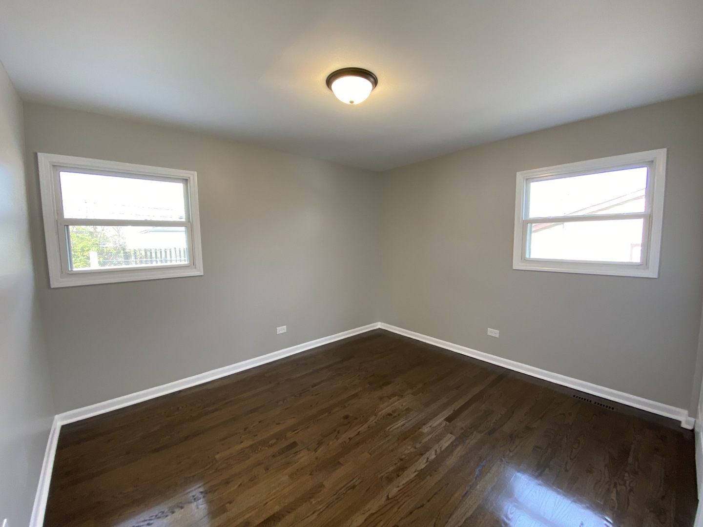 18 South Oltendorf Road Streamwood, IL 60107 - Photo 8 of 21 a view of an empty room with wooden floor and a window