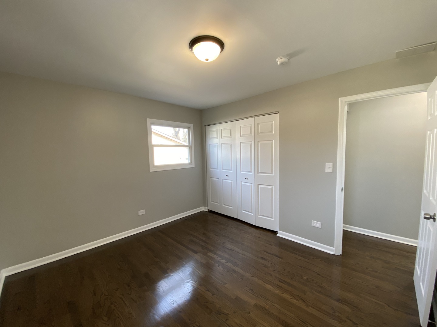 18 South Oltendorf Road Streamwood, IL 60107 - Photo 9 of 21 an empty room with wooden floor and windows