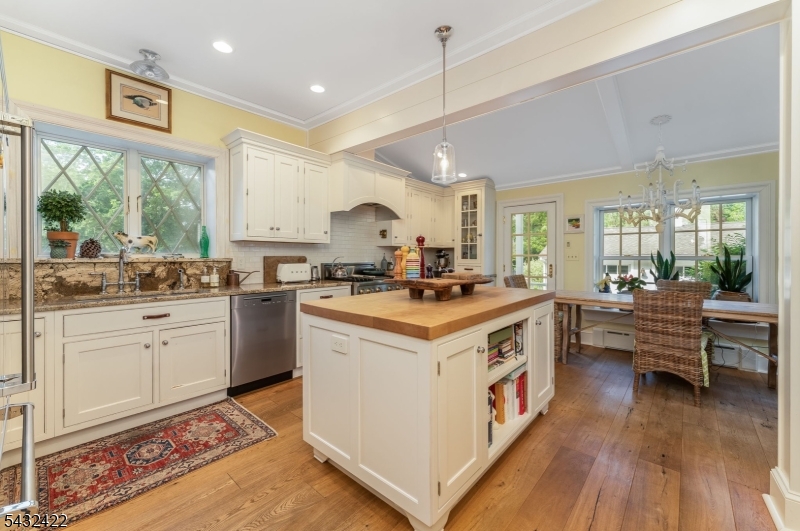 11 New Street Mendham, NJ 07945 - Photo 10 of 35 a kitchen with a sink stove and wooden cabinets