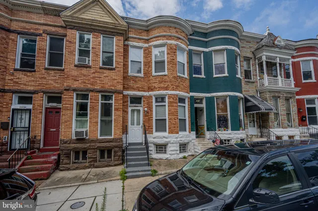 a front view of a house with outdoor seating