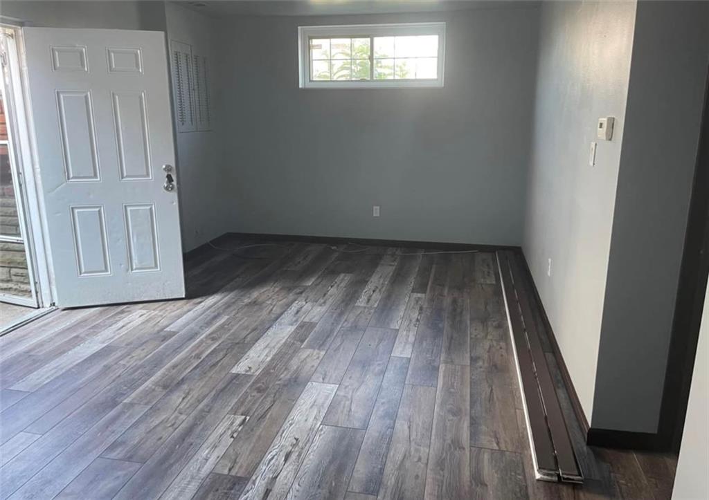 3506 Mayfair Street, Unit B McKeesport, PA 15132 - Photo 3 of 12 an empty room with wooden floor and windows