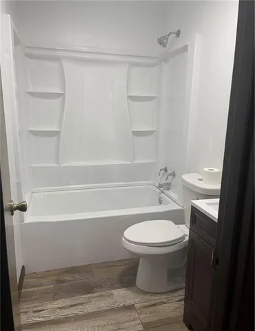 a bathroom with a sink a toilet and bathtub