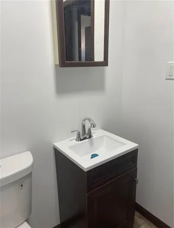 a bathroom with a sink a toilet and mirror