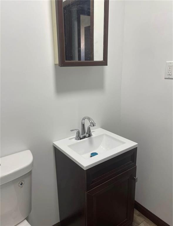 3506 Mayfair Street, Unit B McKeesport, PA 15132 - Photo 7 of 12 a bathroom with a sink a toilet and mirror