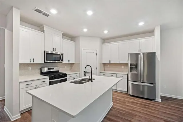 a stove top oven sitting inside of a kitchen