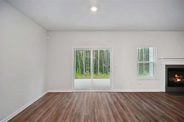 a view of a room window fireplace and wooden floor