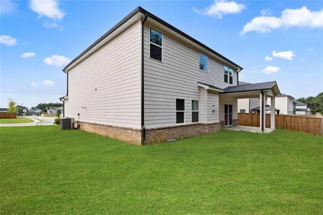 an aerial view of a house with a yard basket ball court and outdoor seating