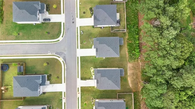 an aerial view of residential houses with outdoor space