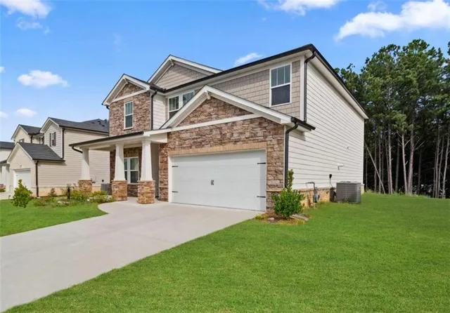 a front view of a house with a garden and plants