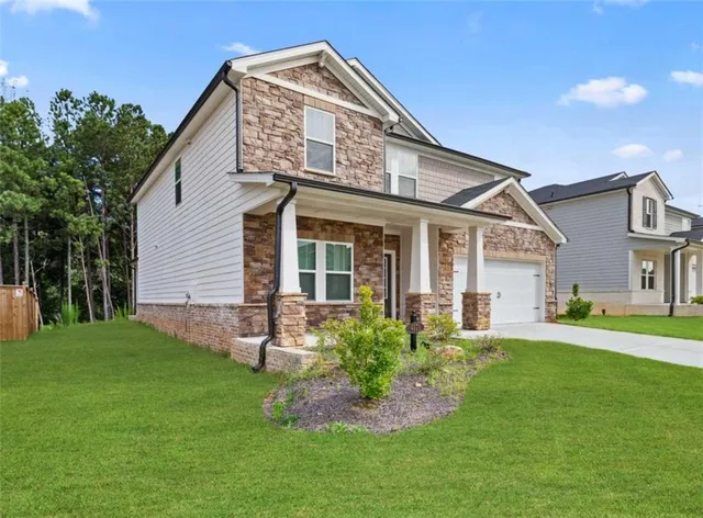 a front view of a house with a yard