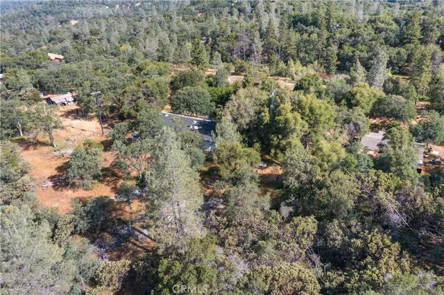 an aerial view of a houses with yard