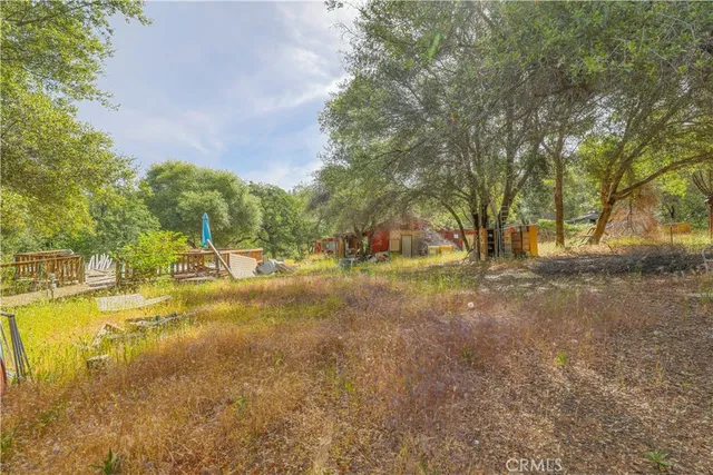 a view of yard with swimming pool and trees