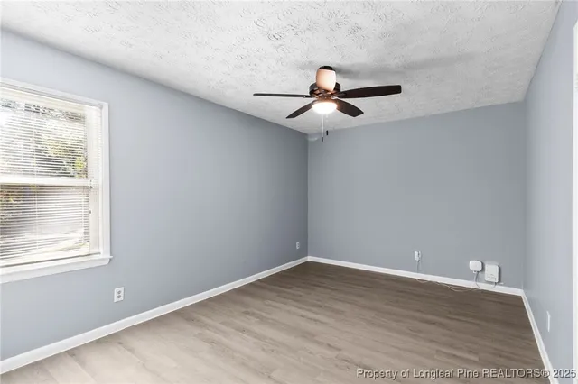 a view of a room with wooden floor and windows