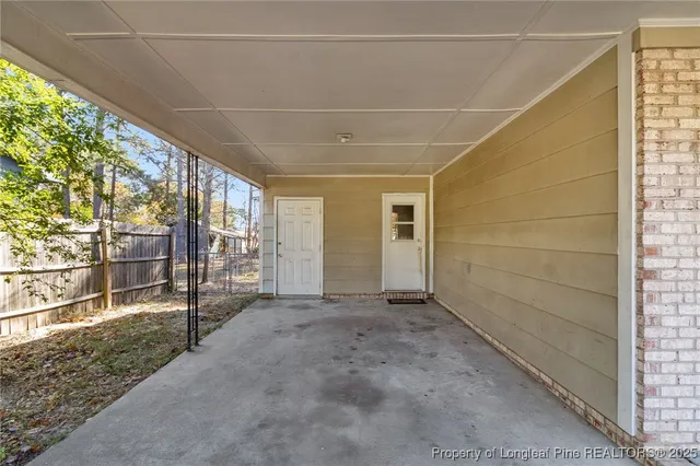 a view of a porch with wooden floor and fence
