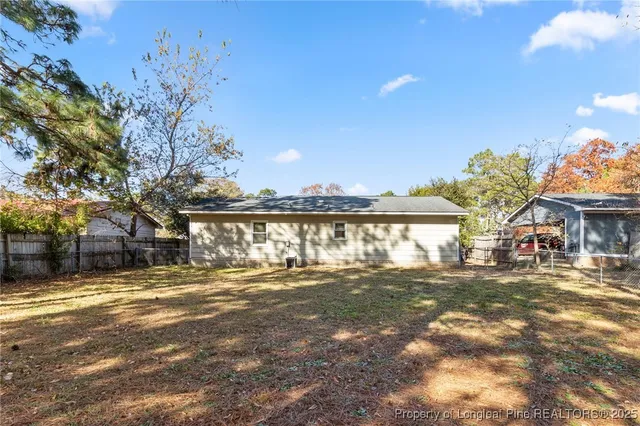 a view of a yard with a house in the background