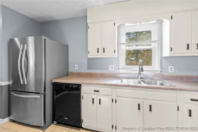 a kitchen with kitchen island granite countertop a sink cabinets and stainless steel appliances