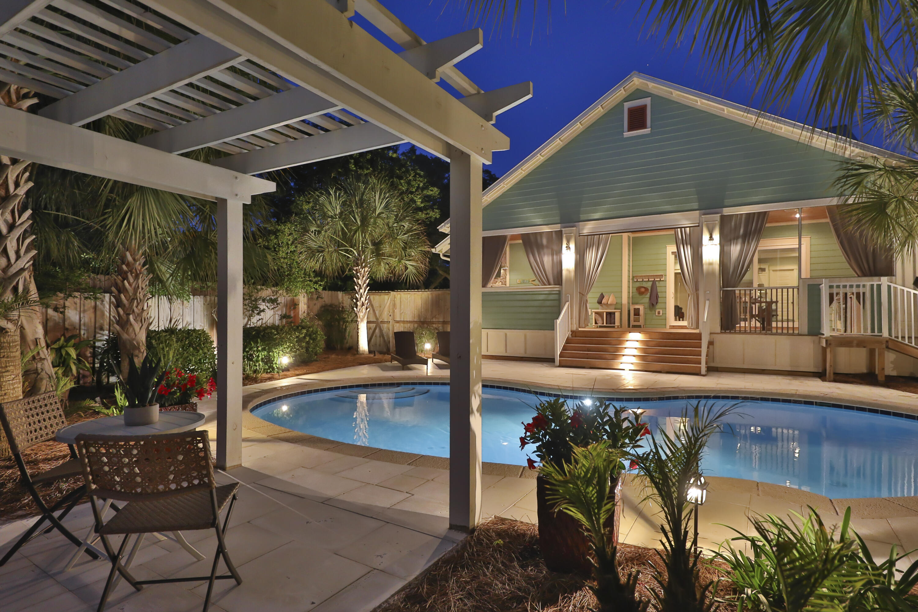 a view of a patio with table and chairs and potted plants
