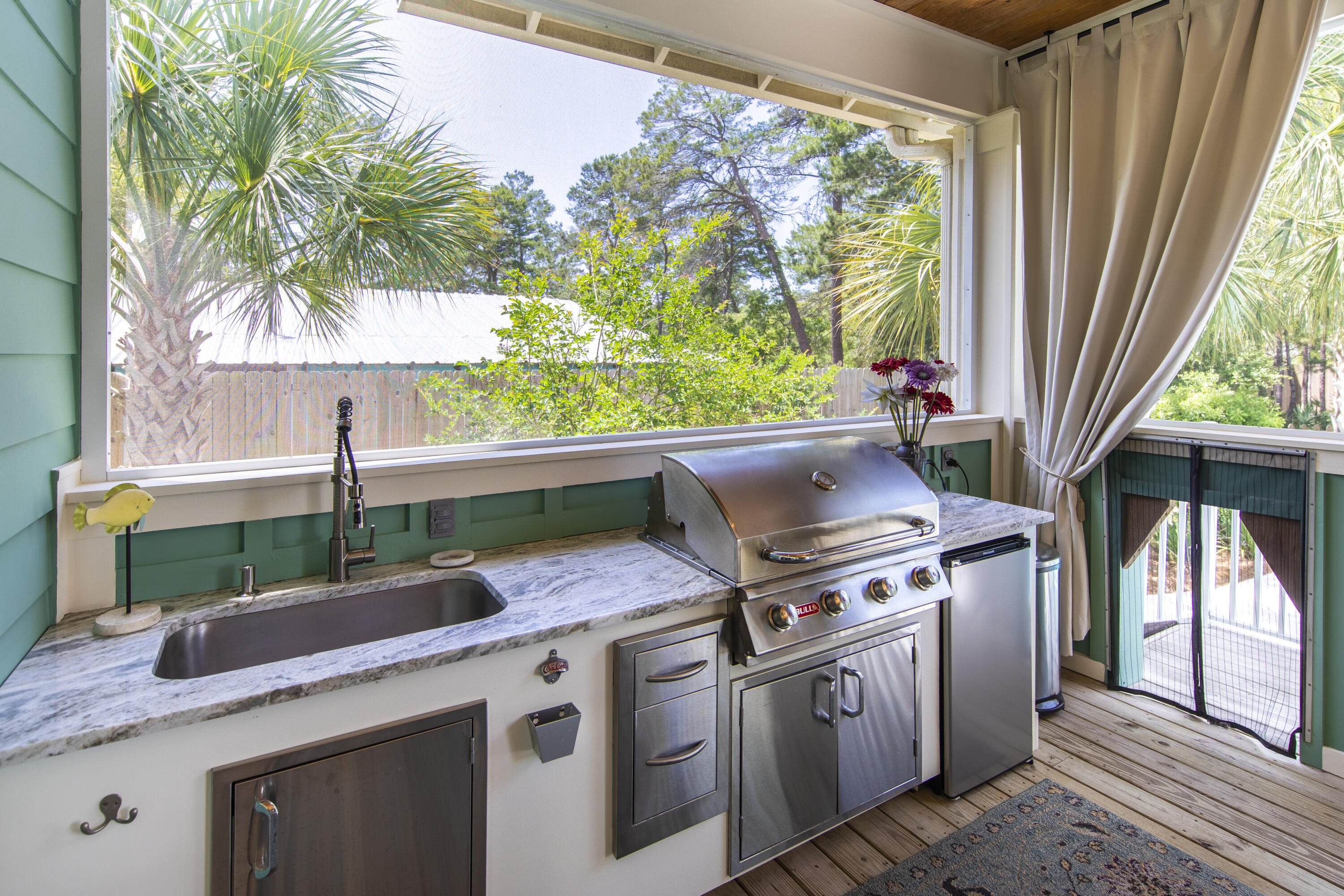 491 North Orange Street Inlet Beach, FL 32461 - Photo 36 of 65 a kitchen with kitchen island a stove a sink and a large window