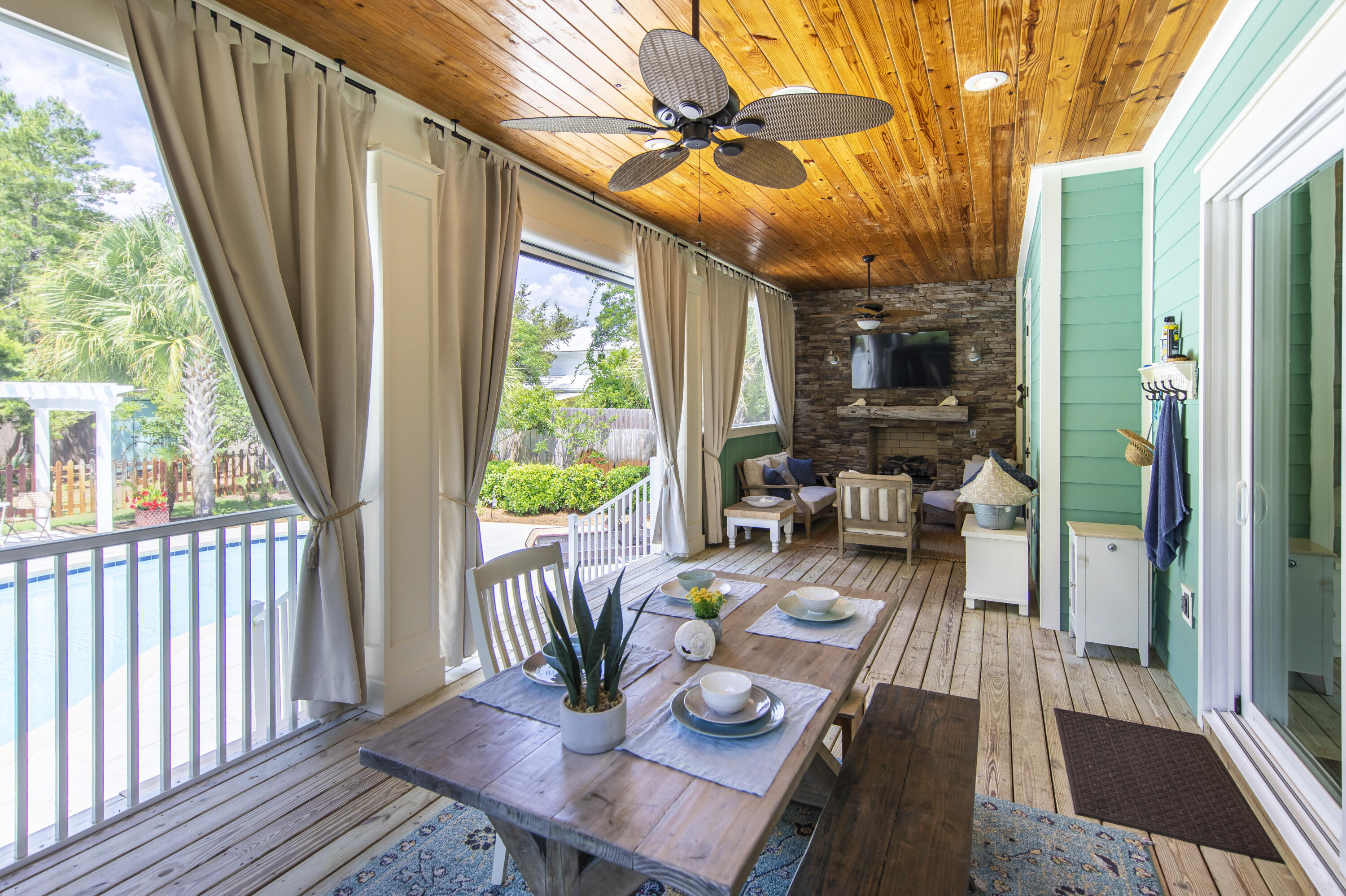 491 North Orange Street Inlet Beach, FL 32461 - Photo 37 of 65 a view of a patio with couches chairs potted plants and wooden floor