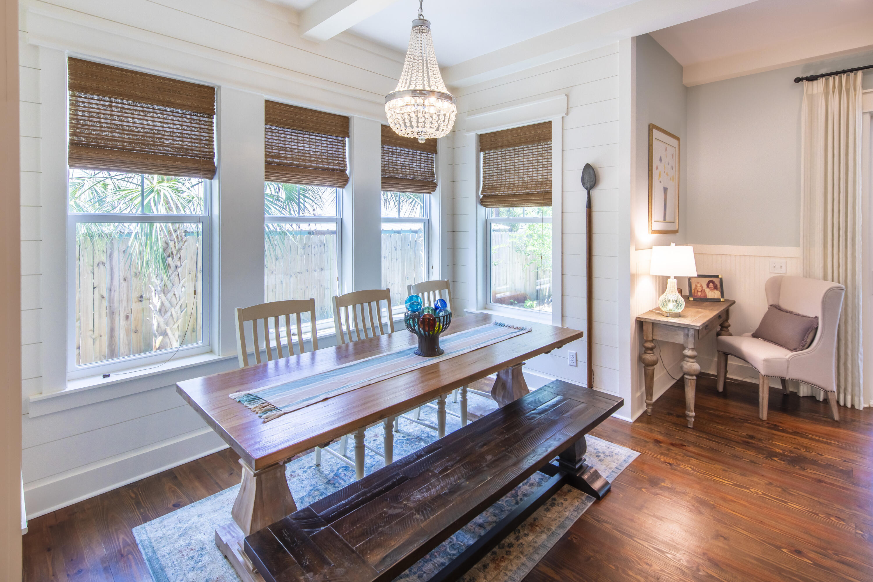 491 North Orange Street Inlet Beach, FL 32461 - Photo 44 of 65 a dining room with furniture wooden floor a rug a potted plant and a chandelier