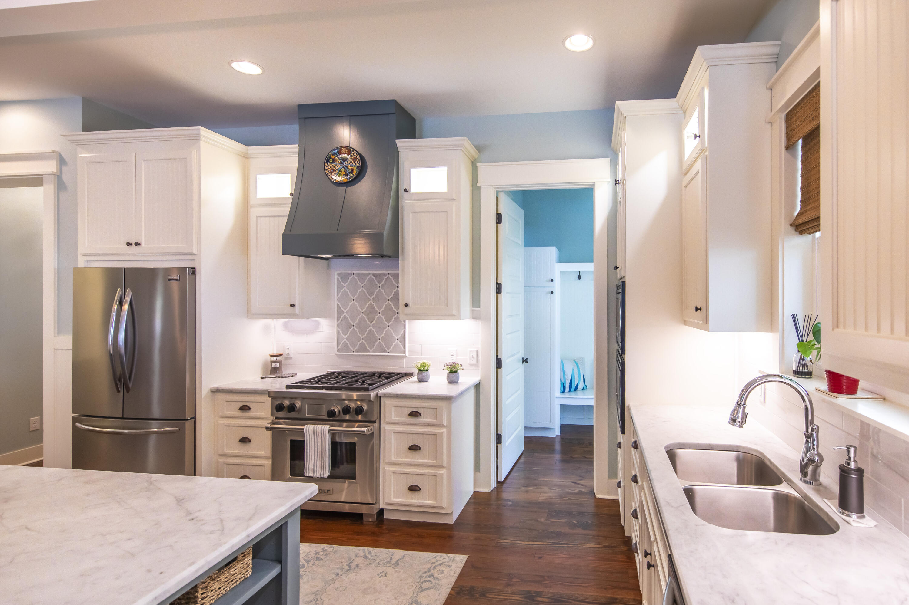 491 North Orange Street Inlet Beach, FL 32461 - Photo 49 of 65 a kitchen with stainless steel appliances a sink a stove a refrigerator and cabinets
