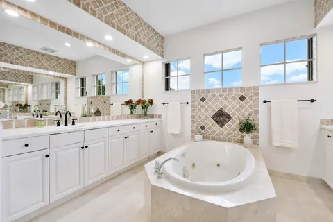 a bathroom with a granite countertop sink a toilet and shower