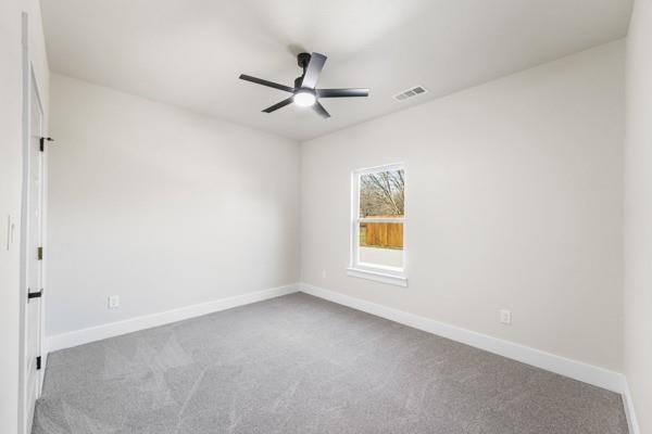 508 Luzon Street Tool, TX 75143 - Photo 18 of 40 an empty room with a window and a ceiling fan
