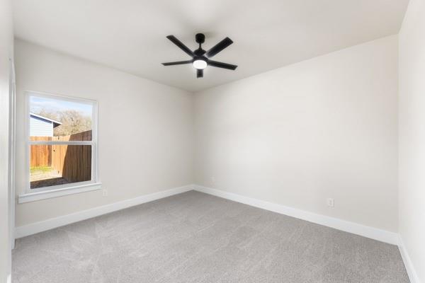 508 Luzon Street Tool, TX 75143 - Photo 26 of 40 an empty room with a window and a ceiling fan