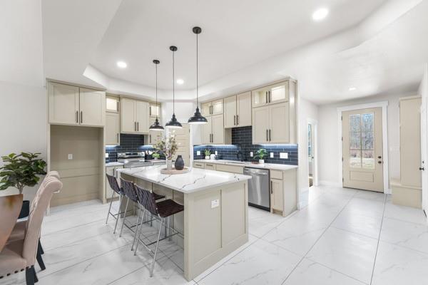508 Luzon Street Tool, TX 75143 - Photo 9 of 40 a kitchen with a refrigerator a sink dishwasher with a dining table and chairs