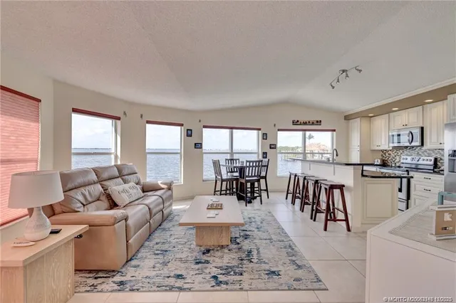 a living room with furniture dining table and a large window