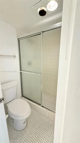 a bathroom with a toilet and a shower