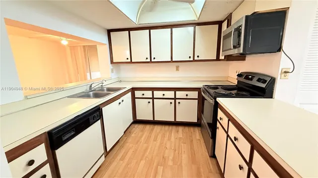 a kitchen with a sink a stove and cabinets