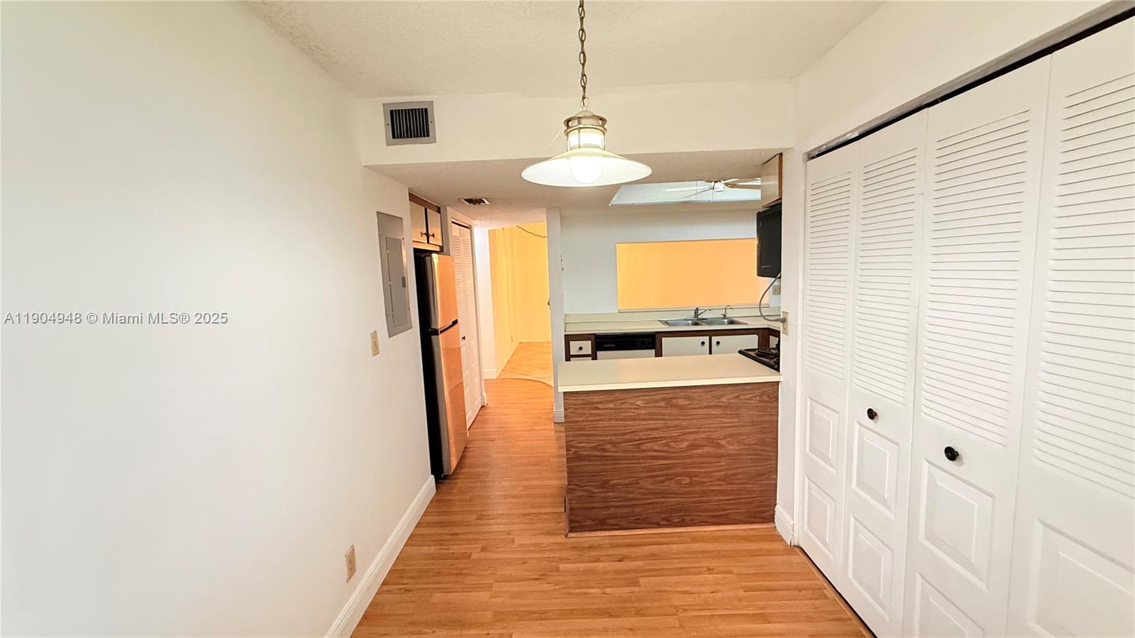 1811 Sabal Palm Drive, Unit 208 Davie, FL 33324 - Photo 6 of 28 a view of a kitchen from the hallway