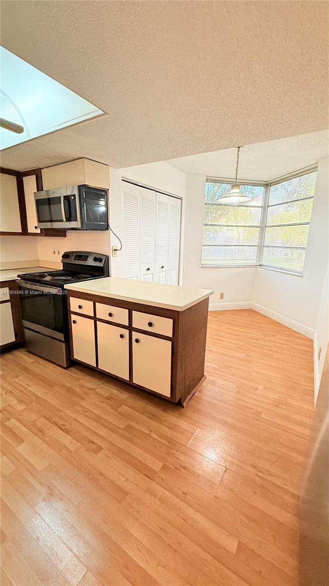 1811 Sabal Palm Drive, Unit 208 Davie, FL 33324 - Photo 8 of 28 a kitchen with stainless steel appliances granite countertop a stove and a sink