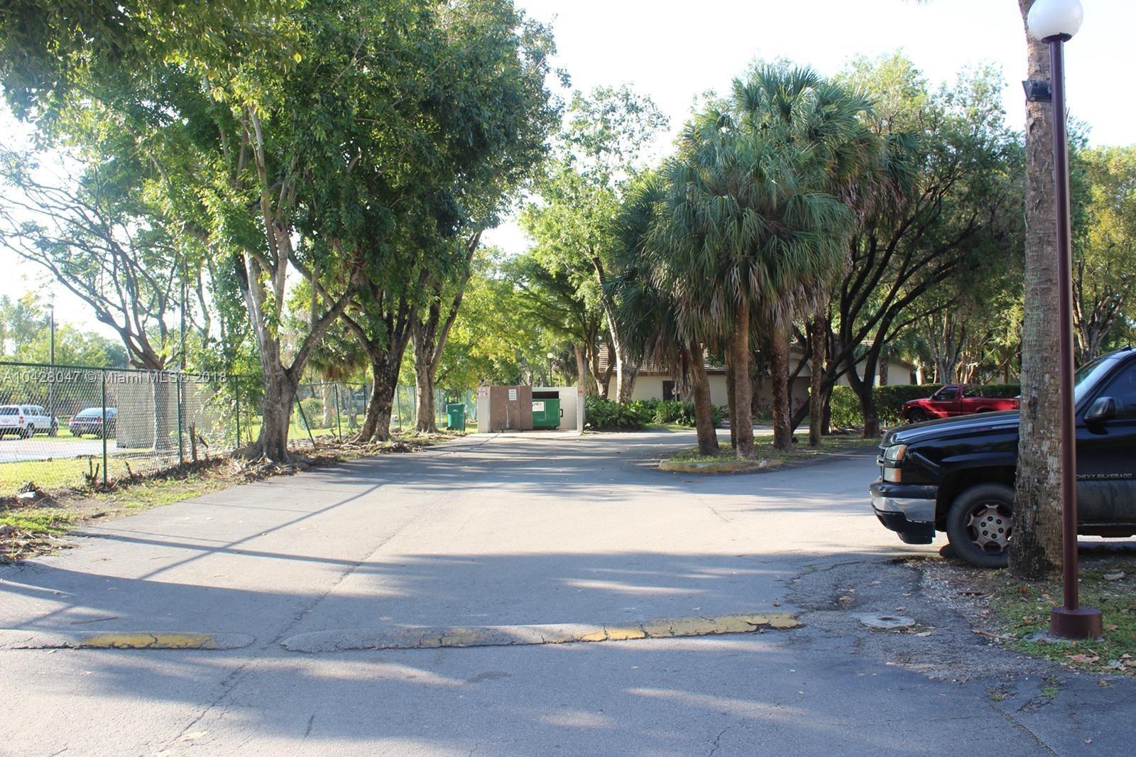 9511 Southwest 138th Place, Unit 9511 Miami, FL 33186 - Photo 17 of 17 a view of park with large trees