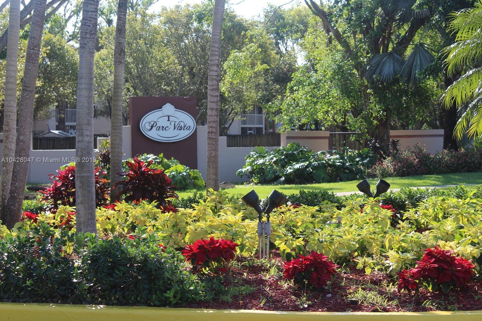 9511 Southwest 138th Place, Unit 9511 Miami, FL 33186 - Photo 2 of 17 a view of a garden with flowers