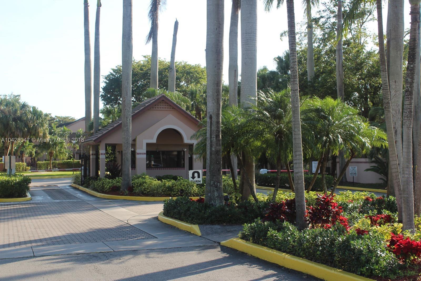 9511 Southwest 138th Place, Unit 9511 Miami, FL 33186 - Photo 3 of 17 a front view of a house with garden